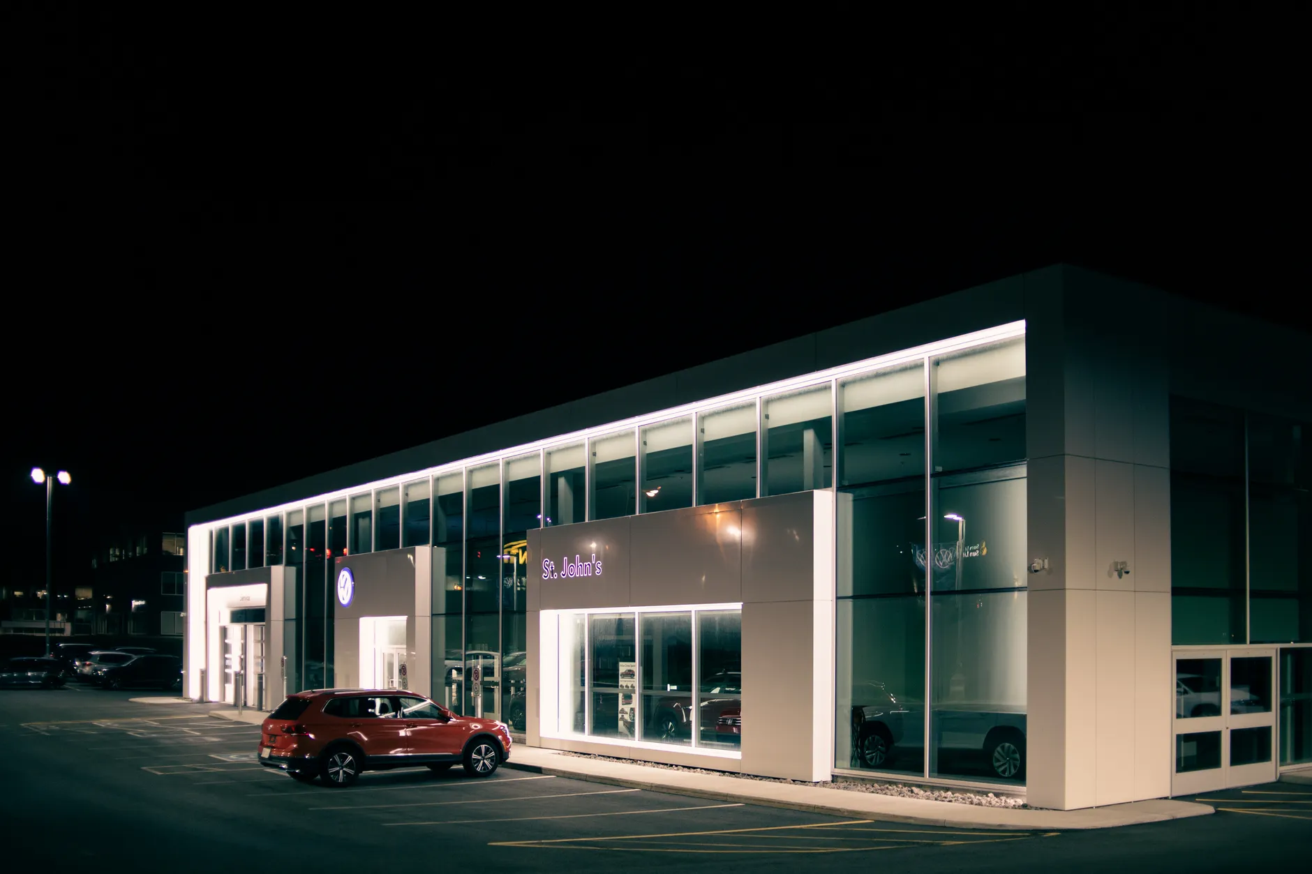 Three charged after $10M luxury car dealership fire