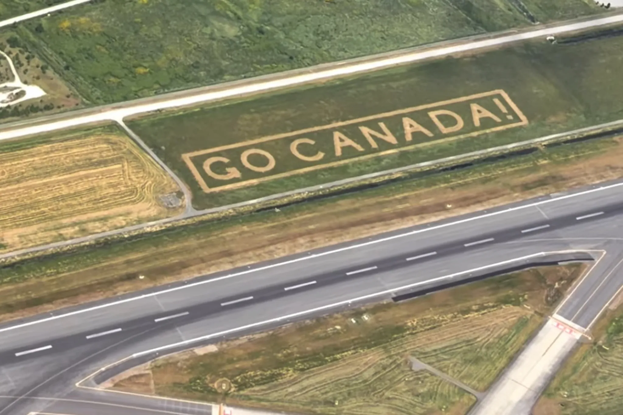 GO CANADA message carved beside YVR runway ahead of World Cup